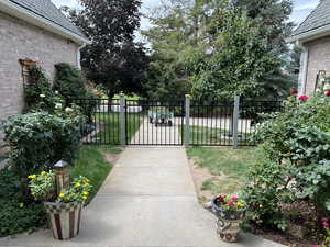 View of gate with a lawn