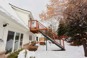 Snow covered house with a deck