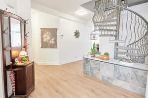 Foyer entrance with light wood-type flooring