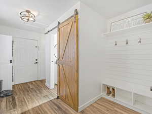 Foyer entrance with hardwood / wood-style flooring and a barn door