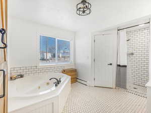 Bathroom featuring independent shower and bath and a baseboard radiator