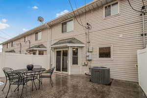 Rear view of property featuring central AC and a patio