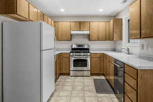 Kitchen with appliances with stainless steel finishes and sink