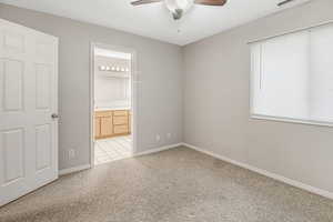 Carpeted spare room with ceiling fan