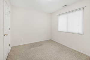 Carpeted spare room featuring a textured ceiling