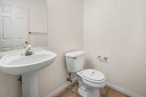 Bathroom featuring tile patterned flooring and toilet