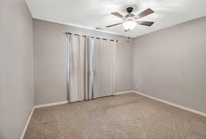 Spare room with ceiling fan and carpet floors