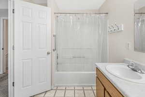 Bathroom with vanity, tile patterned flooring, and shower / bath combo