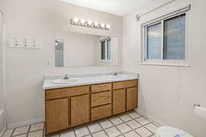 Bathroom with tile patterned flooring, vanity, and toilet