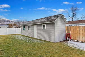 View of outbuilding featuring a yard