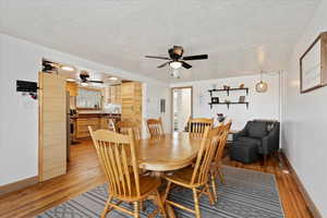 Dining room with sink, hardwood / wood-style flooring, and a textured ceiling