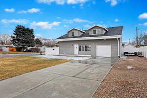 View of front of home with a garage and a front yard