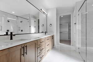 Bathroom featuring walk in shower and vanity