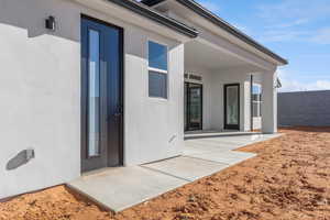 Property entrance with a patio area