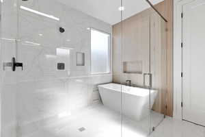 Bathroom featuring tile walls and independent shower and bath