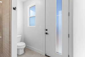 Bathroom with tile patterned floors and toilet