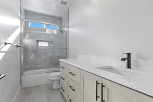 Full bathroom with vanity, toilet, and combined bath / shower with glass door