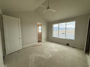 Unfurnished bedroom featuring visible vents, baseboards, ceiling fan, and lofted ceiling