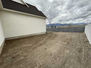 View of yard featuring a fenced backyard and a mountain view