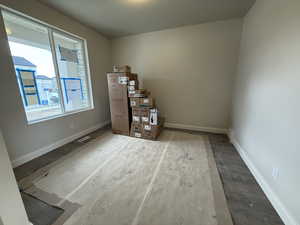 Interior space with baseboards, visible vents, and wood finished floors