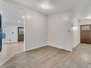 Entryway featuring a textured ceiling and light wood-type flooring