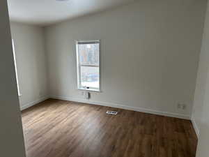 Unfurnished room with dark hardwood / wood-style flooring