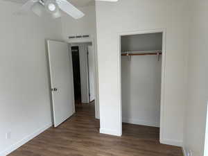 Unfurnished bedroom featuring dark hardwood / wood-style flooring and a closet