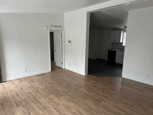 Unfurnished room featuring dark wood-type flooring