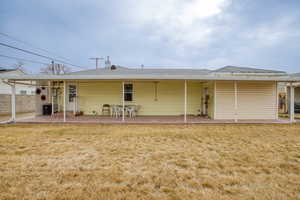 Rear view of property featuring a patio, a yard, and central AC unit