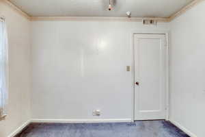 Unfurnished room with carpet floors and a textured ceiling