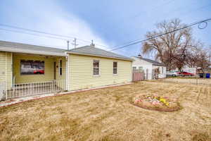 Back of property with a yard