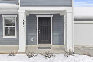 View of snow covered property entrance