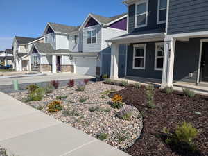 View of side of home featuring a garage and a porch