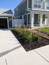 View of front facade featuring a garage and a porch