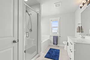 Full bathroom featuring tile patterned flooring, vanity, toilet, and plus walk in shower