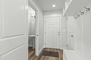 Mudroom with wood-type flooring