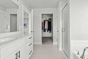 Bathroom with vanity and a shower with shower door