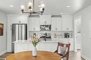 Dining room with hardwood / wood-style flooring and sink