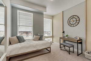 Bedroom with light colored carpet