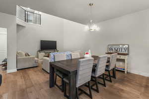 Dining space with an inviting chandelier and light wood-type flooring