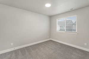 Unfurnished room with carpet