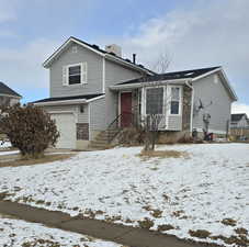 View of front of property featuring a garage.