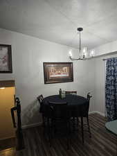 Dining area featuring dark hardwood / wood-style floors and a textured ceiling