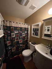 Bathroom with vanity, toilet and tub/shower combo