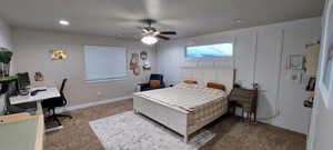 Carpeted bedroom with ceiling fan