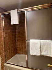 Bathroom with enclosed tub / shower combo