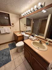 Primary bathroom with dual vanities and toilet