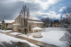 View of front of house adjacent to green space.