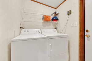 Clothes washing area featuring  washing machine and clothes dryer