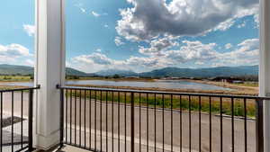 Balcony with a water and mountain view